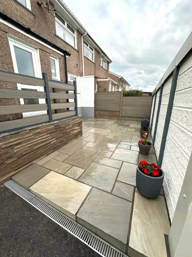Sandstone patio with composite fencing and split face cladding